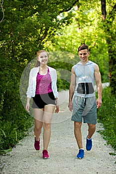 Active young couple on a wlak in the park photo