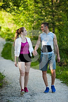 Active young couple on a wlak in the park photo