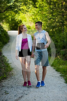 Active young couple on a wlak in the park photo