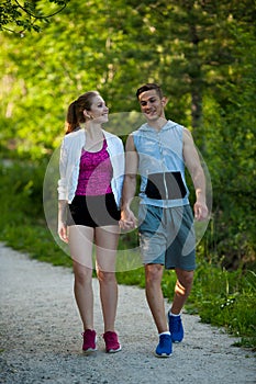 Active young couple on a wlak in the park