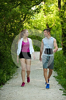 Active young couple on a wlak in the park photo