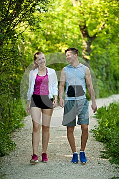 Active young couple on a wlak in the park photo