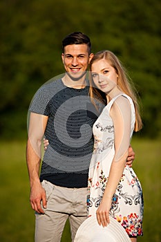 Active young couple on a wlak in the park on hot summer afternoon photo