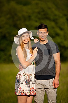 Active young couple on a wlak in the park on hot summer afternoon photo