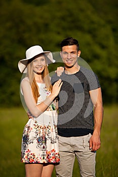 Active young couple on a wlak in the park on hot summer afternoon