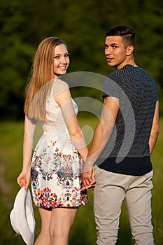 Active young couple on a wlak in the park on hot summer afternoon photo