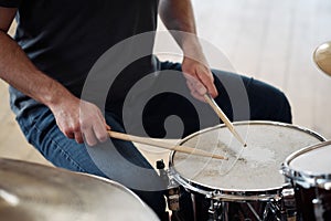 Active young drummer playing drums