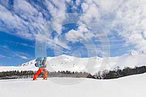 Active young man backcountry skiing on a beautiful sunny day, wi photo