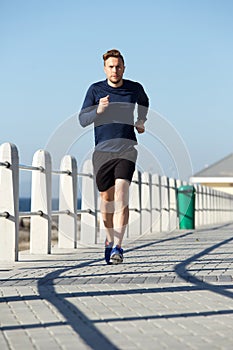 Active young man running outside