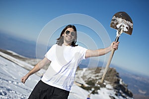 Active young man shoveling snow