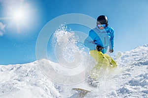 Active young man snowboarding photo