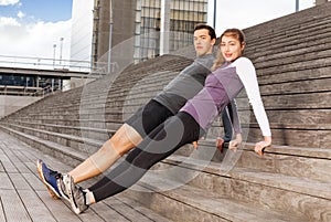 Active young people doing reverse plank exercises