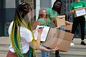 Active young people enjoys volunteering at food and clothes bank photo