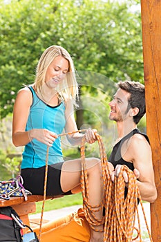 Active young woman climbing rope relax terrace