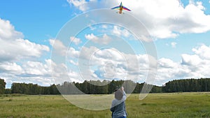 Active young woman flying kite outdoor