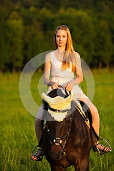 Active young woman ride a horse in nature