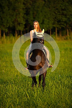 Active young woman ride a horse in nature