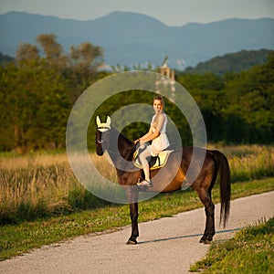 Active young woman ride a horse in nature