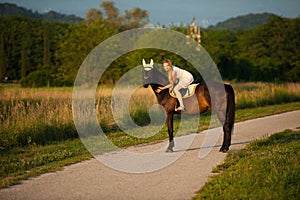 Active young woman ride a horse in nature