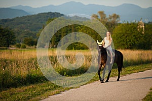 Active young woman ride a horse in nature