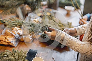 Actively involved in a workshop, a young lady creates handmade Christmas ornaments.