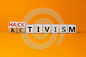 Activism or hacktivism symbol. Turned wooden cubes and changed the concept word Activism to Hacktivism. Beautiful orange table photo