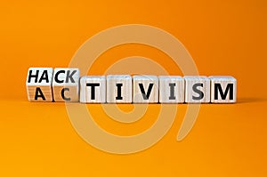 Activism or hacktivism symbol. Turned wooden cubes and changed the concept word Activism to Hacktivism. Beautiful orange table photo