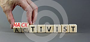 Activist or hacktivist symbol. Businessman turns wooden cubes and changes the word Activist to Hacktivist. Beautiful grey table