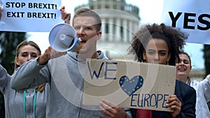 Activists chanting in megaphone, love Europe without borders, migration crisis