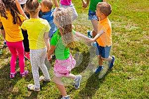 Activities for kids of different ages on green lawn