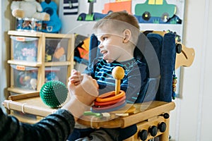 Activities for kids with disabilities. Preschool Activities for Children with Special Needs. Boy with with Cerebral photo