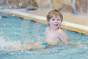 Activities on the pool, toddler boy swimming