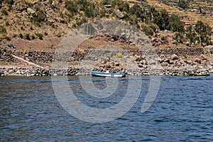 Activity of fishermen and their boats in the LlachÃ³n peninsula on Lake Titicaca. photo