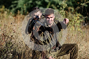 Activity for real men concept. Hunters with rifles in nature environment. Hunters gamekeepers looking for animal or bird