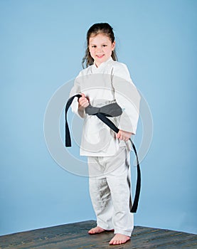 Activity and sport. Karate gives feeling of confidence. Strong and confident kid. Girl little child in white kimono with