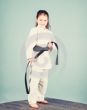 Activity and sport. Karate gives feeling of confidence. Strong and confident kid. Girl little child in white kimono with