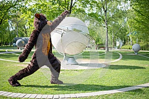 actor dressed as bear aerobics near sculptural photo