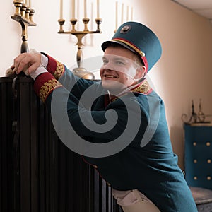 Actor dressed historical costume in interior of old theater.
