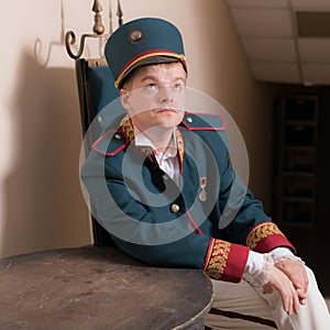 Actor dressed historical costume in interior of old theater.