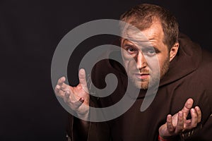 The actor in the guise of a beggar on a dark background