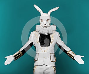 Actor posing in white rabbit suit on color blue