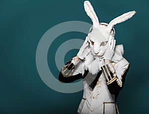 Actor posing in white rabbit suit with earphones