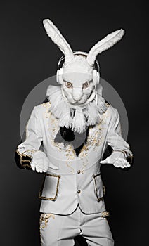 Actor posing in white rabbit suit with earphones