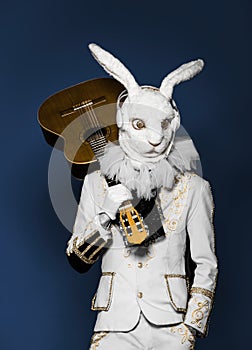 Actor posing in white rabbit suit playing guitar