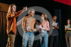 Actors and actresses rehearsing on stage