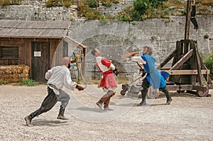 Actors doing a theatrical staging as medieval fighters in the castle of Baux-de-Provence.