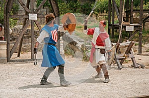 Actors doing a theatrical staging as medieval fighters in the castle of Baux-de-Provence.