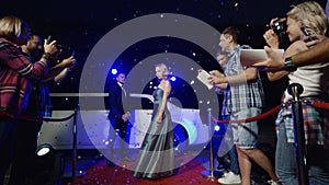 Actress with bodyguards on red carpet