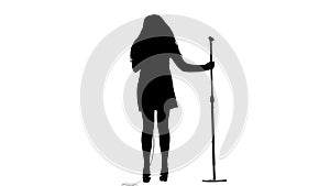 Actress in a retro microphone sings a rock song. White background. Silhouette. Side view. Slow motion