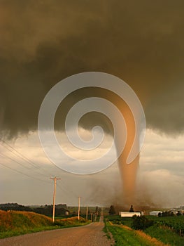 Actual photo of a tornado illuminated by the setting sun touching down in Iowa, narrowly missing a farm.